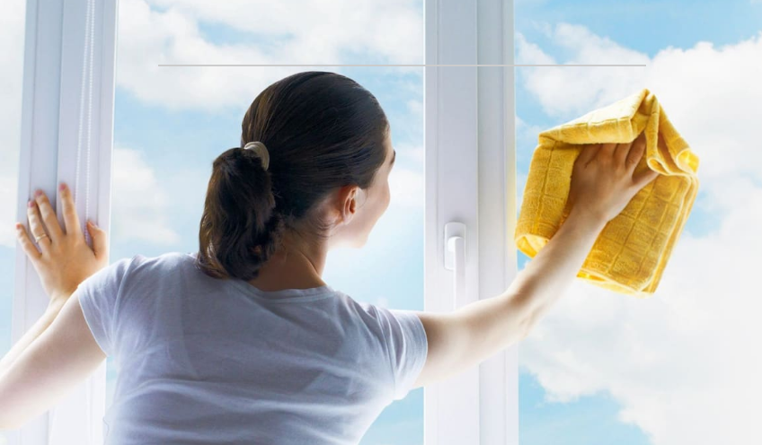 Woman cleaning window
