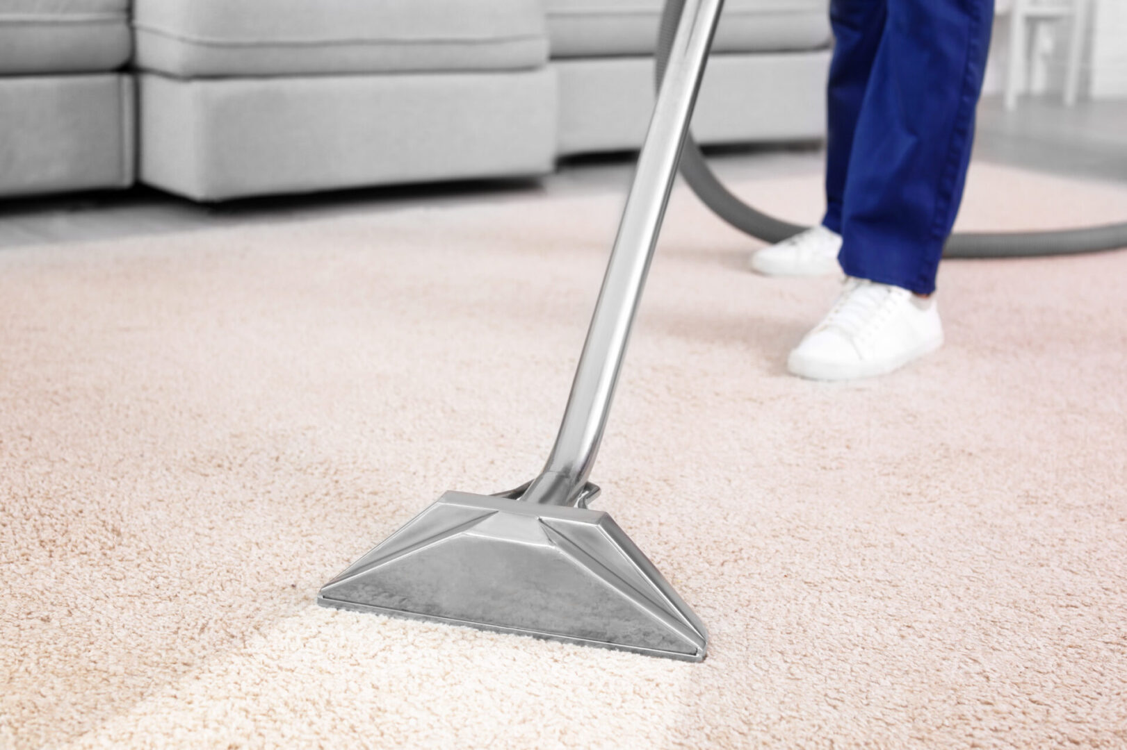 A person is vacuuming the floor of their home.